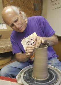 Luke Metz at the pottery wheel
